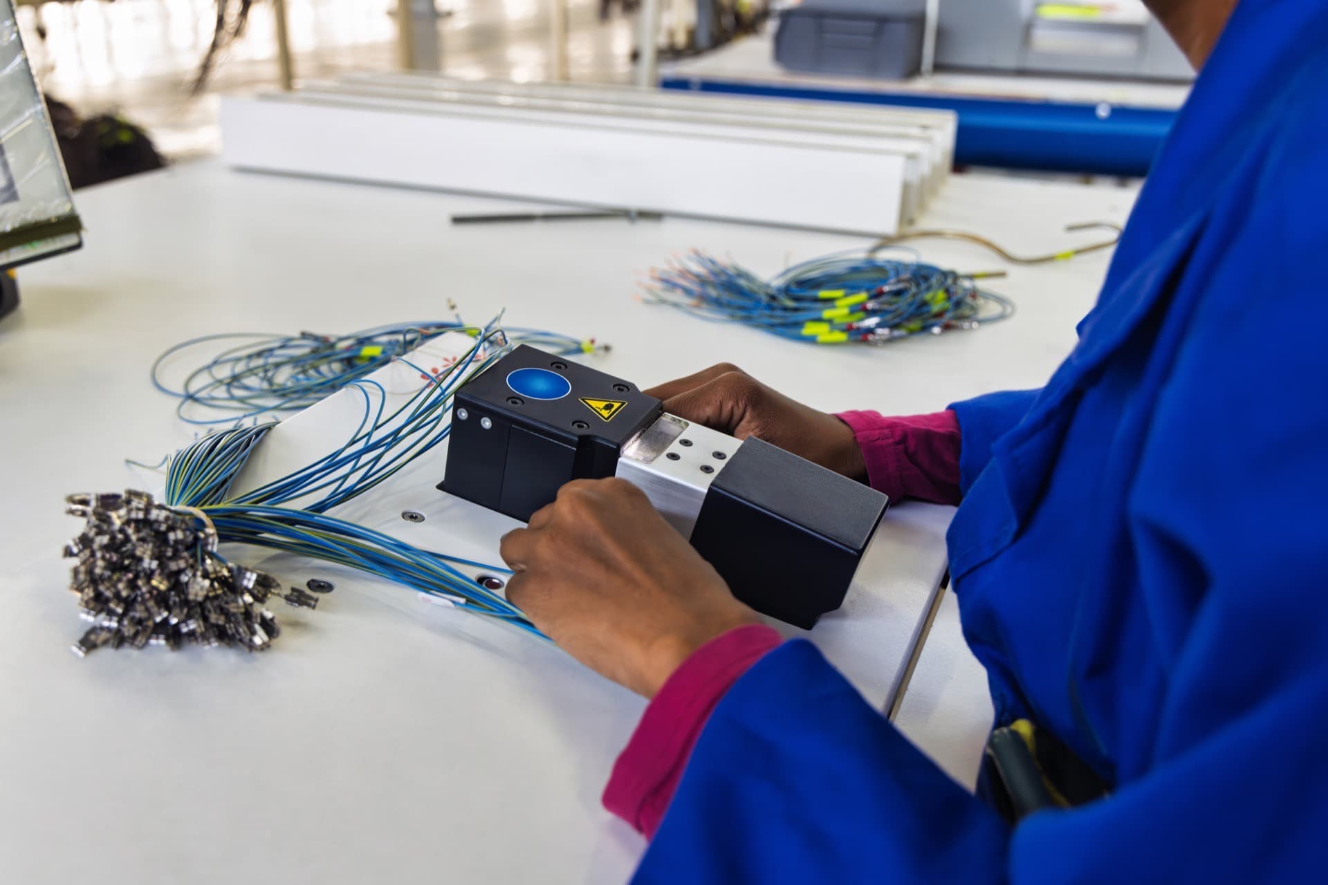 Technician assembling a wired module during a low-volume production run